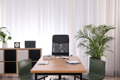 Photo of Director's office with large wooden table. Interior design