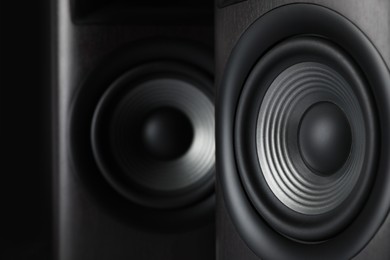 Photo of Modern sound speakers on black background, closeup
