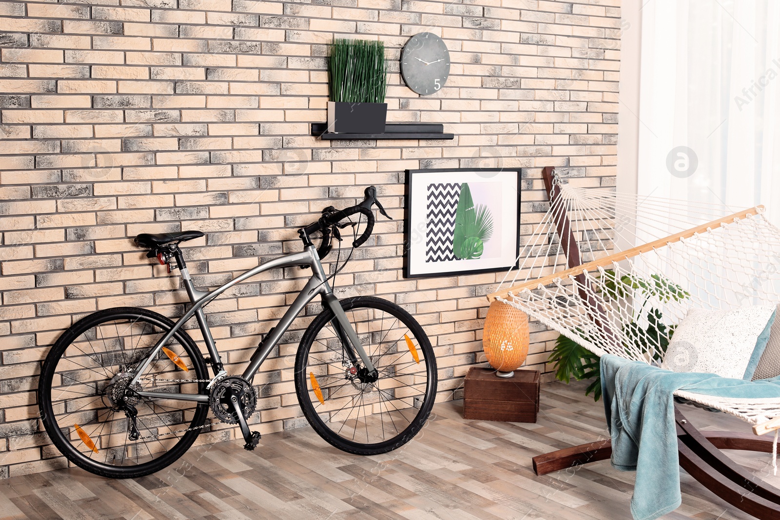 Photo of Modern bicycle and hammock in stylish room interior