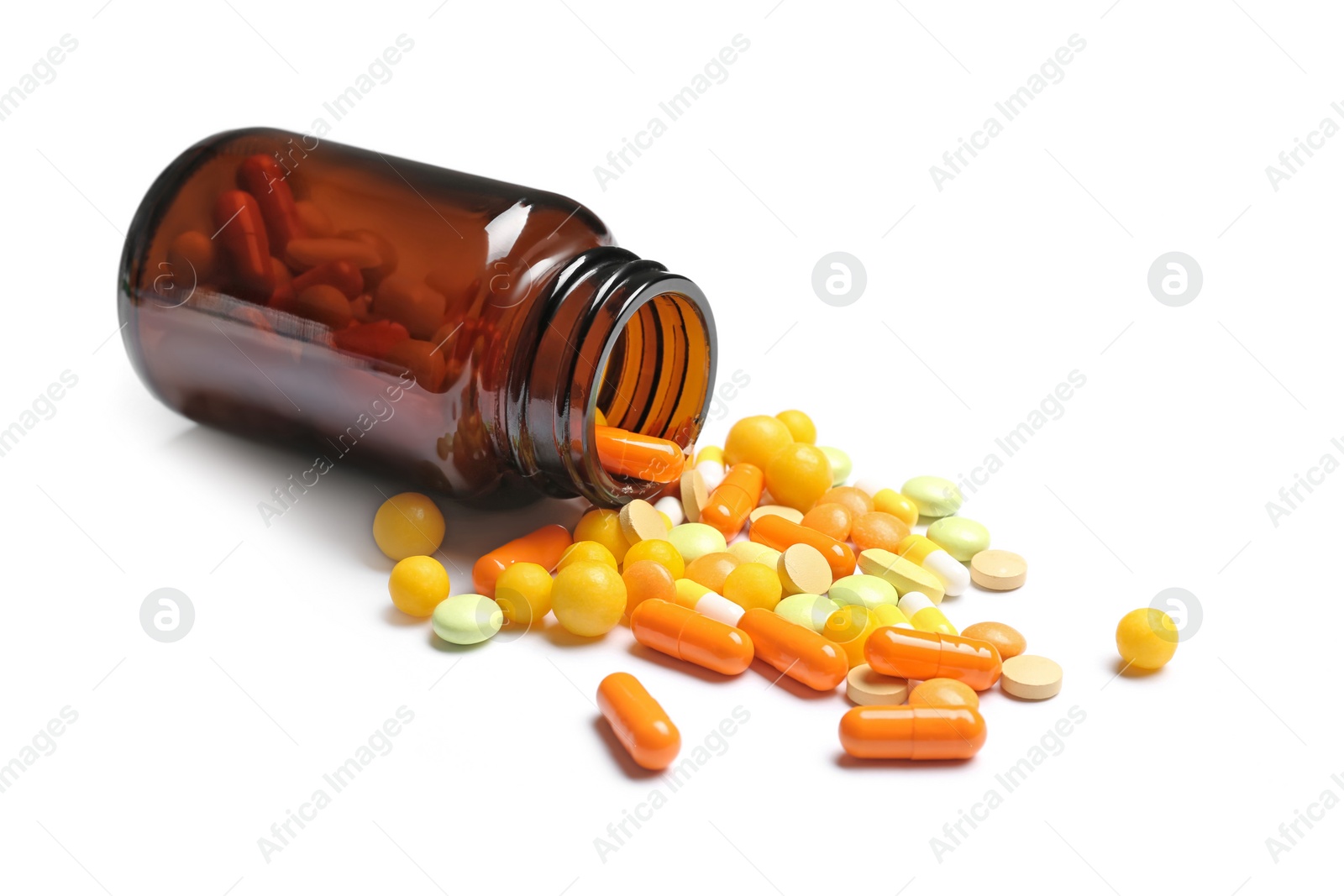 Photo of Bottle with vitamin pills and capsules on white background