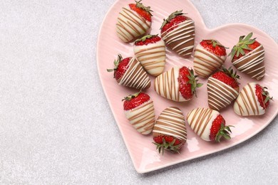 Photo of Heart shaped plate with delicious chocolate covered strawberries on light table, top view. Space for text