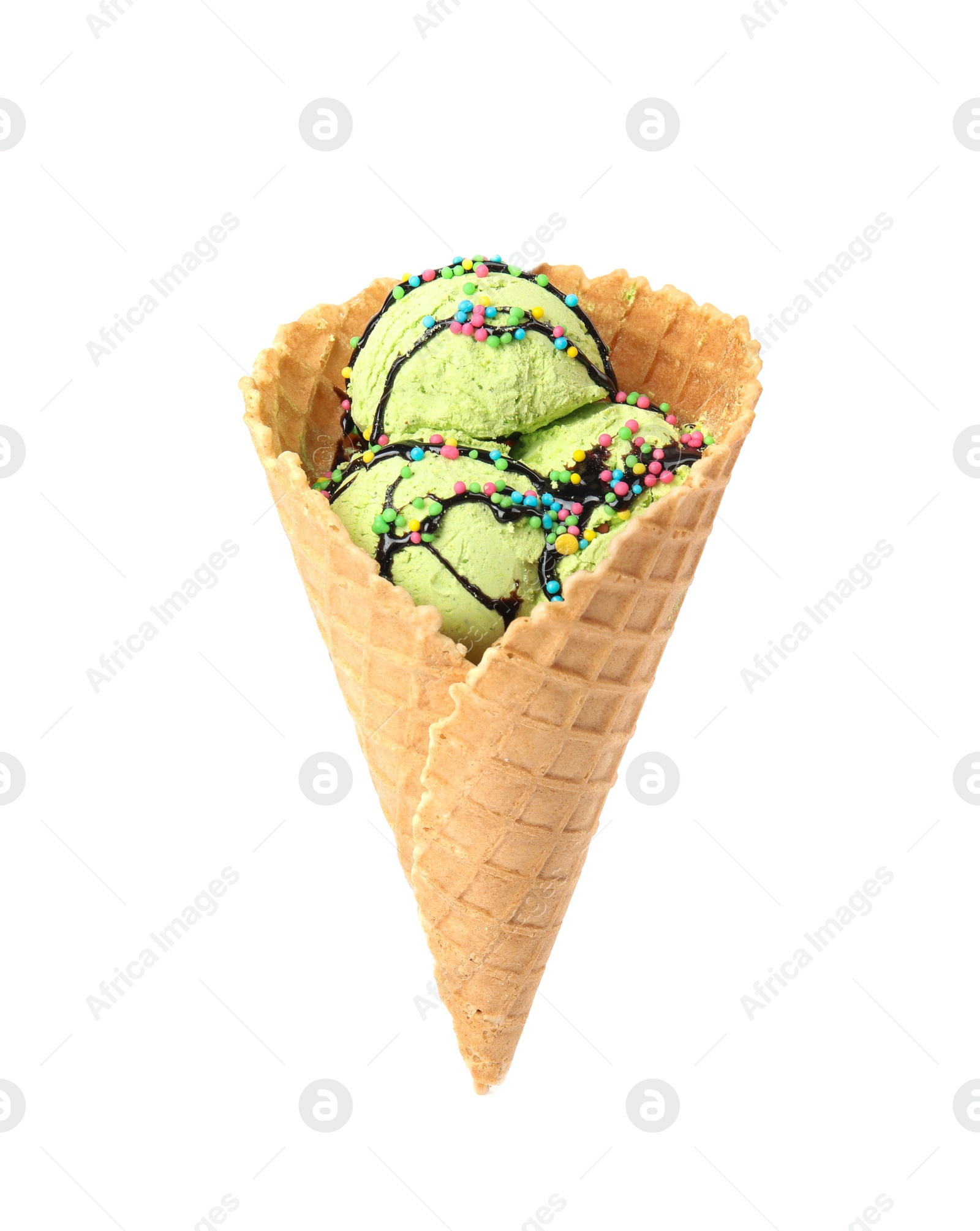 Photo of Delicious ice cream with topping in waffle cone on white background