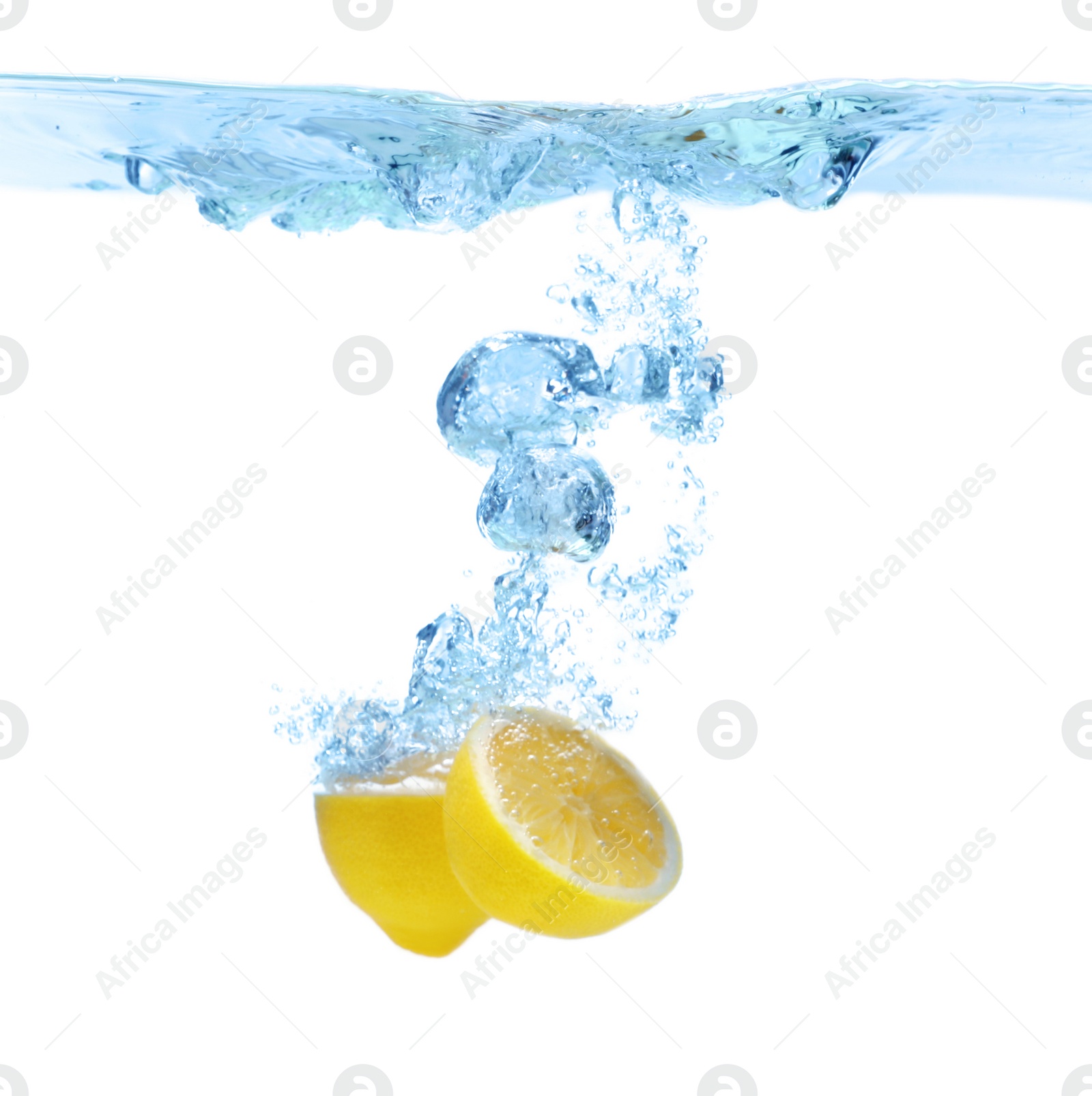 Photo of Cut lemon falling down into clear water against white background