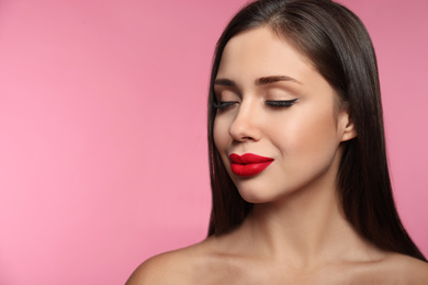 Photo of Beautiful woman with red lipstick on pink background, space for text