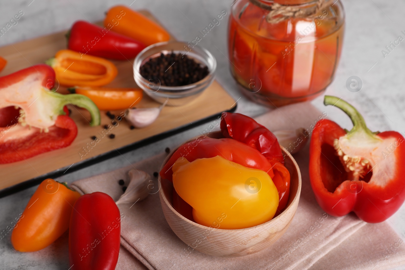 Photo of Delicious bell peppers and ingredients for canning on white table