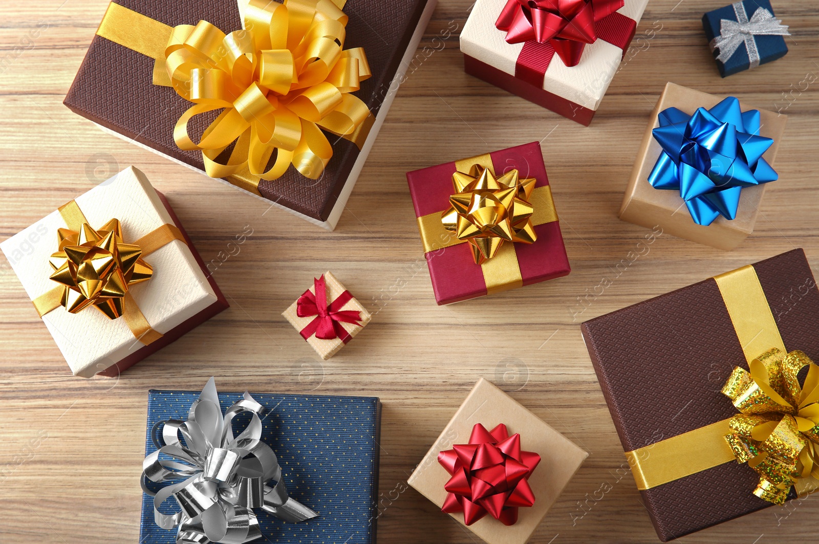 Photo of Flat lay composition with beautiful gift boxes on wooden table