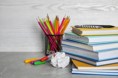 Photo of Different school stationery on table against light background