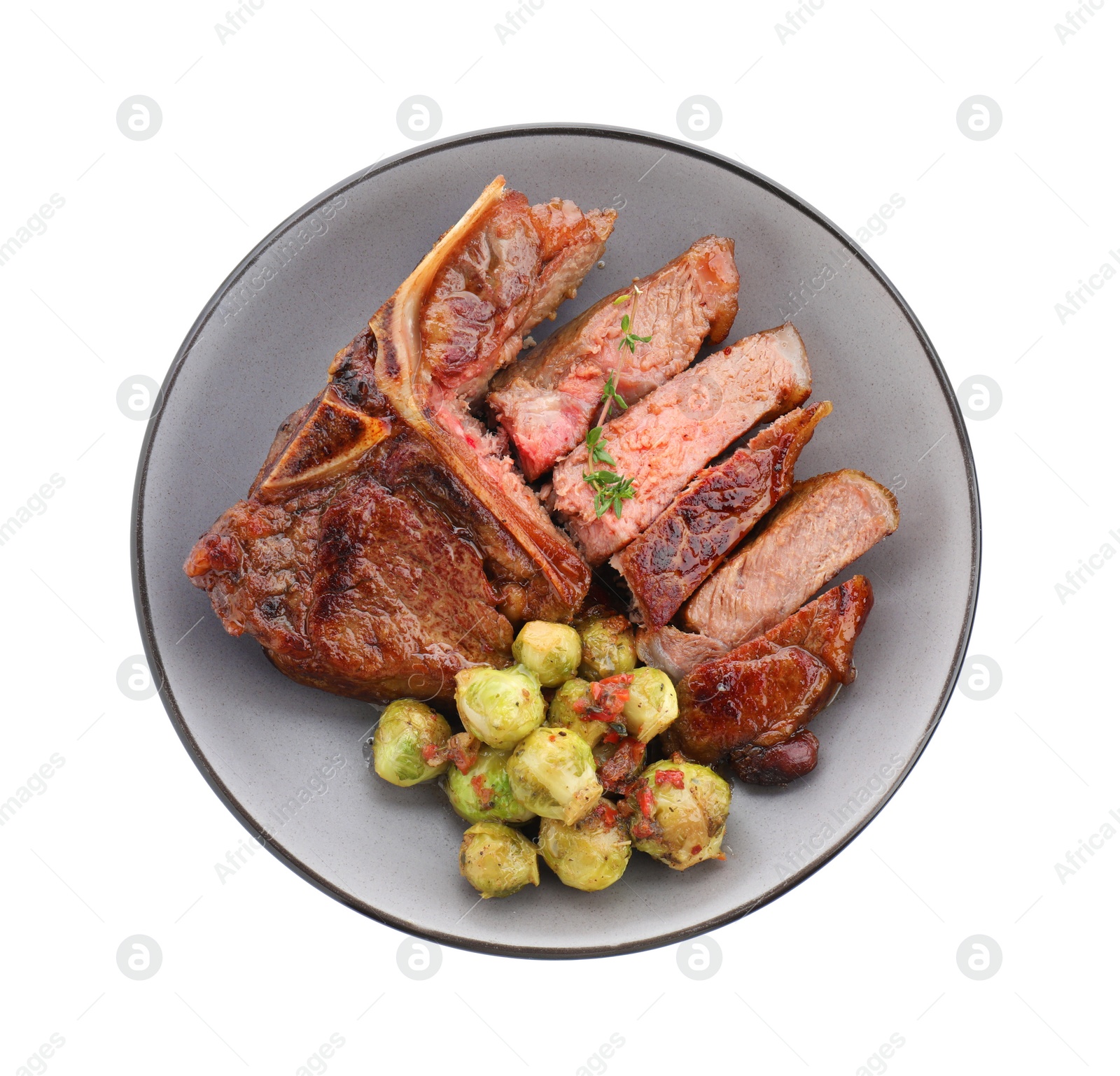 Photo of Delicious fried beef meat, vegetables and thyme isolated on white, top view