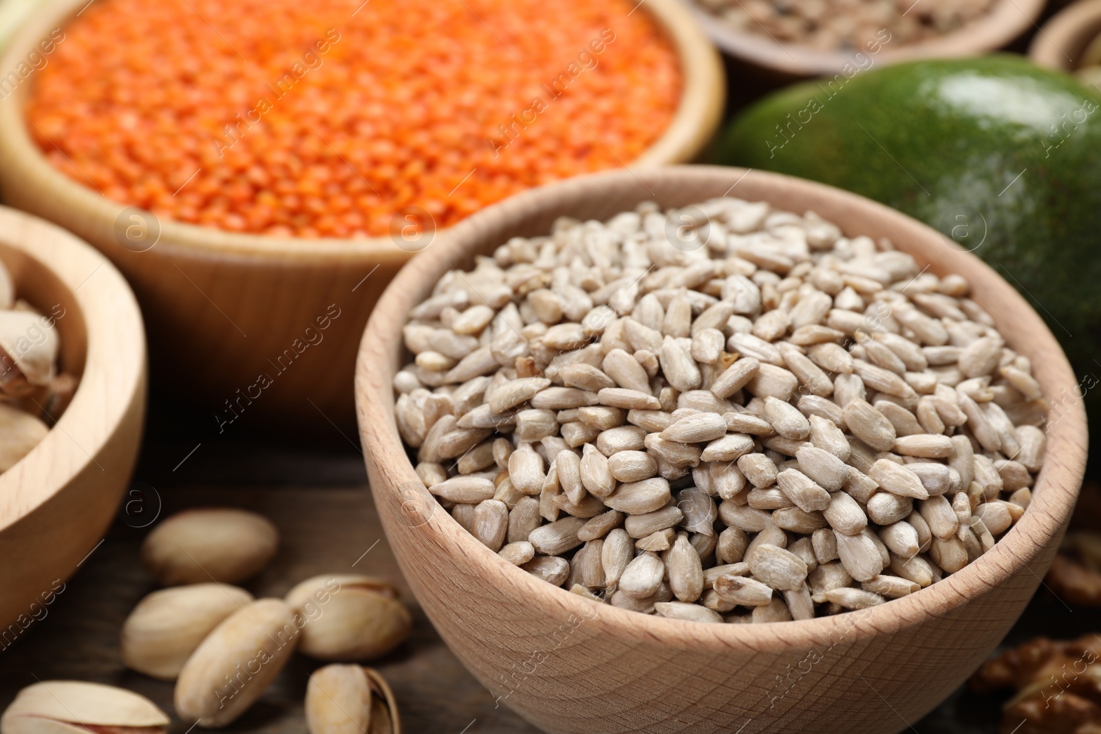 Photo of Different products high in natural fats on wooden table, closeup