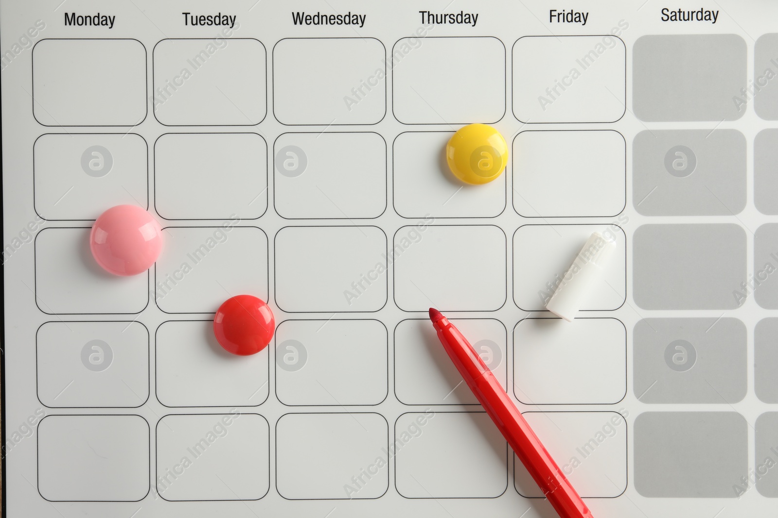 Photo of Timetable. Planner, felt pen and drawing pins, top view