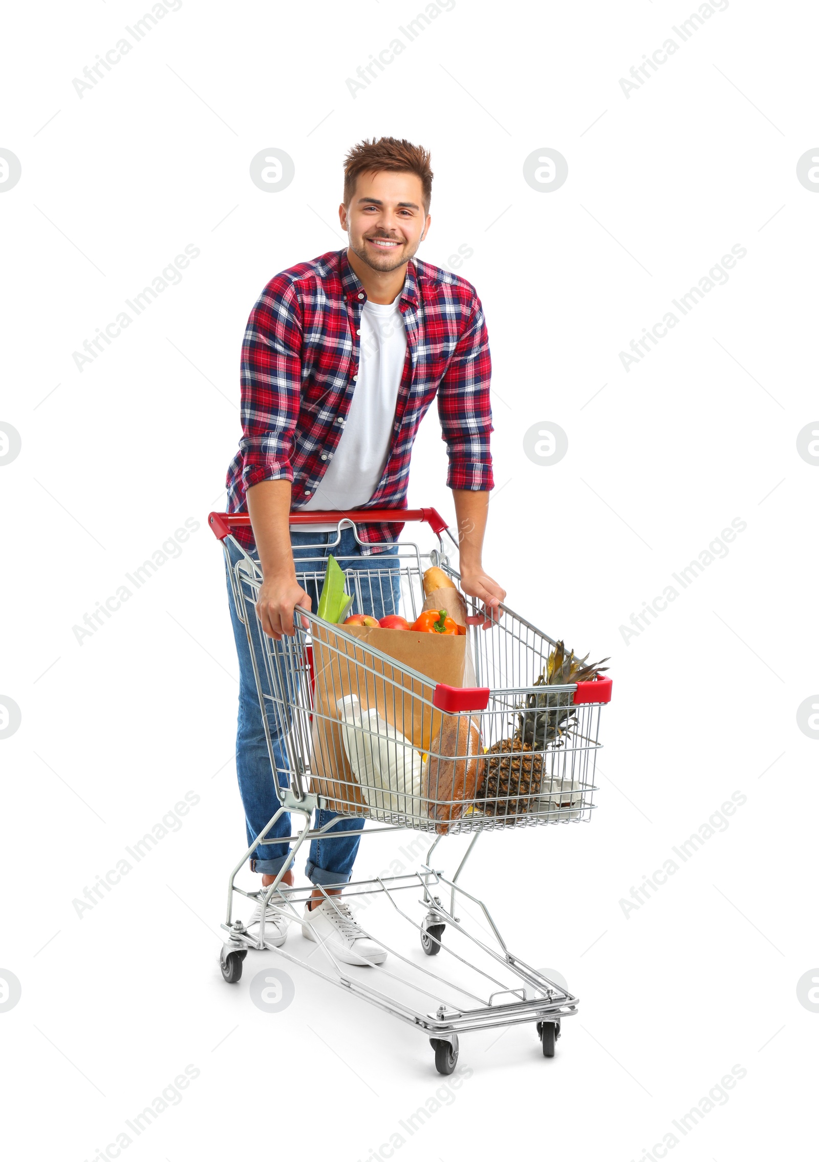 Photo of Young man with full shopping cart on white background