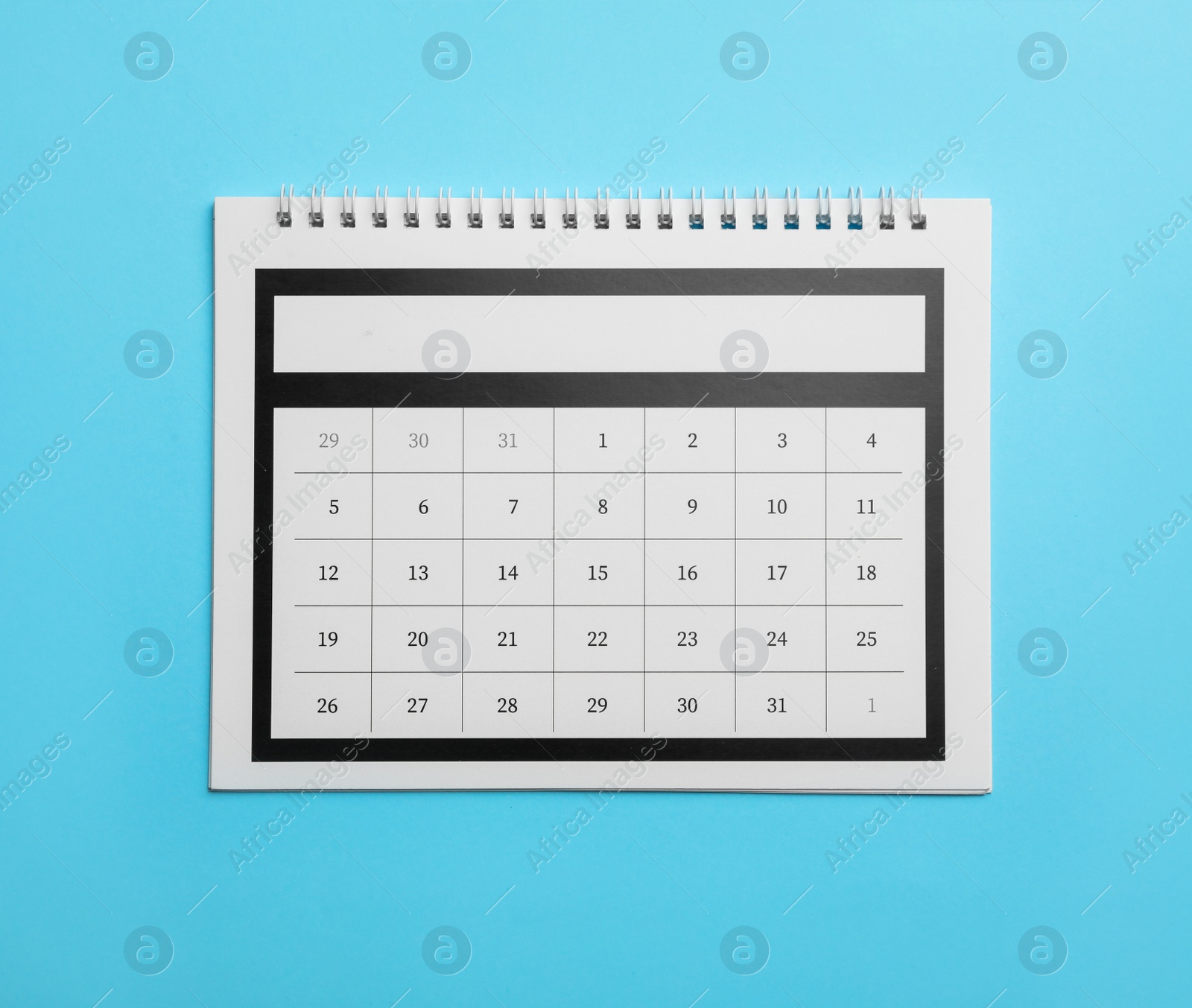 Photo of Paper calendar on light blue background, top view