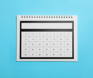 Photo of Paper calendar on light blue background, top view