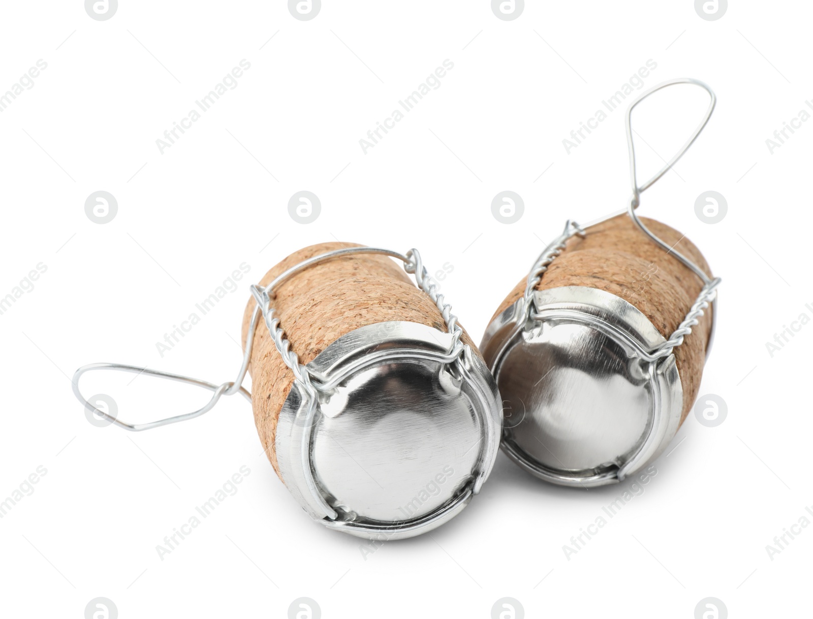 Photo of Sparkling wine corks with muselet caps on white background
