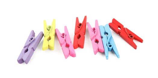 Photo of Many colorful wooden clothespins on white background