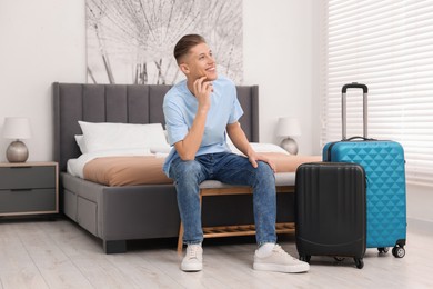 Photo of Smiling guest relaxing in stylish hotel room