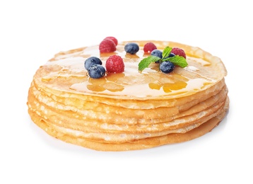 Stack of tasty thin pancakes with maple syrup and fresh berries on white background