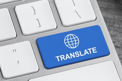 Blue button with word TRANSLATE on computer keyboard, closeup view