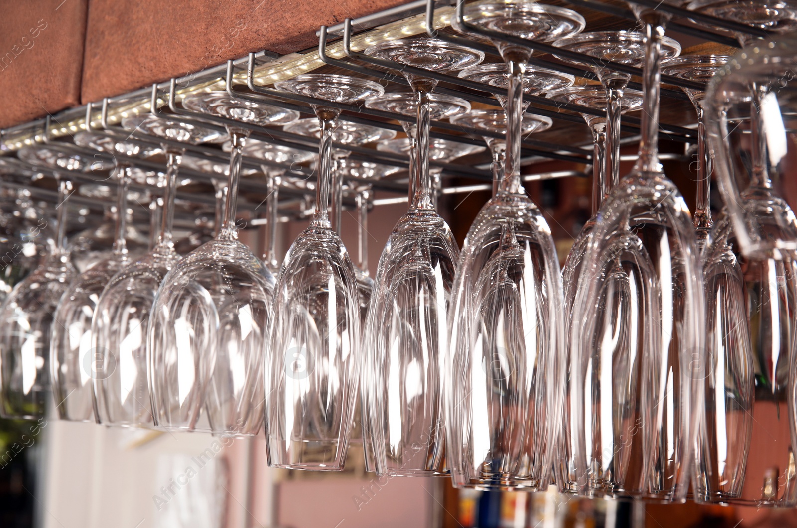 Photo of Clean glasses hanging over counter in bar