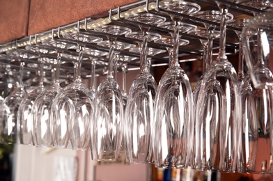 Clean glasses hanging over counter in bar