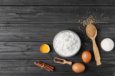 Photo of Composition with flour, eggs and sugar on wooden background, top view