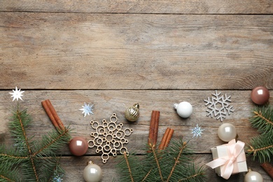 Flat lay composition with Christmas decorations on wooden background, space for text. Winter season