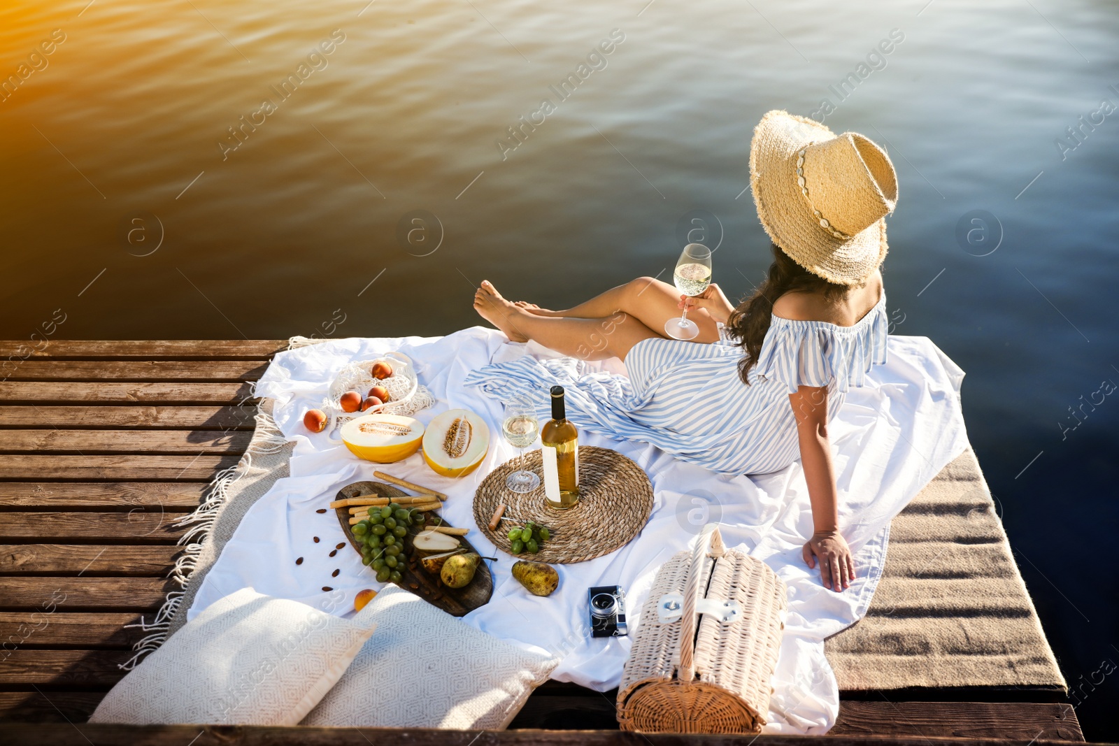 Photo of Young woman spending time on pier at picnic