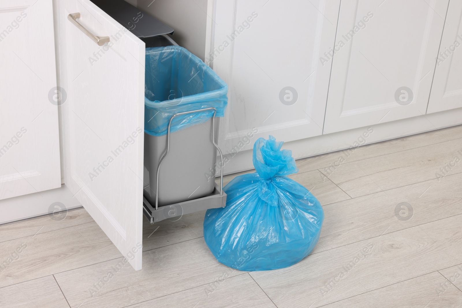 Photo of Plastic garbage bag and trash can indoors