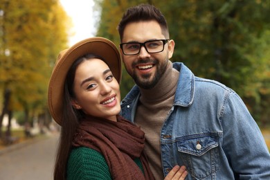 Photo of Happy young couple spending time together in autumn park