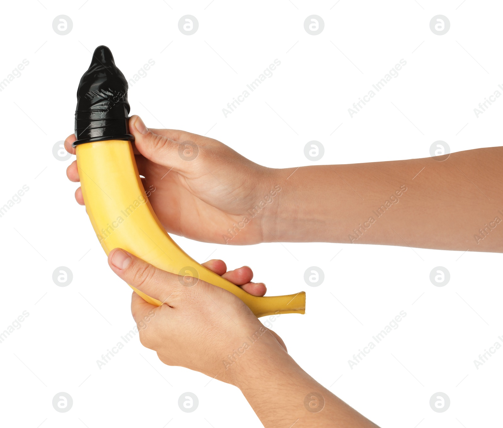 Photo of Woman holding banana in condom on white background, closeup. Safe sex concept