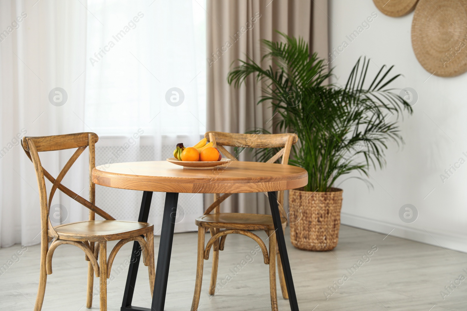 Photo of Stylish room interior with dining table and chairs