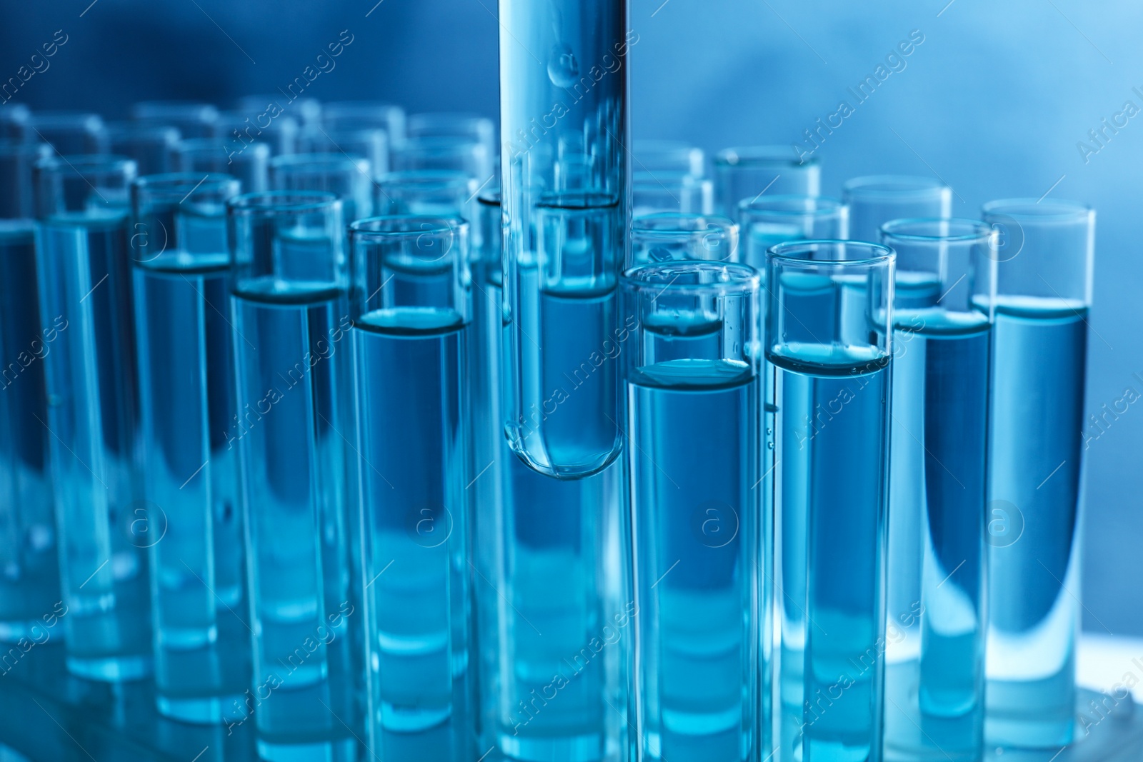 Photo of Taking test tube with liquid sample, closeup