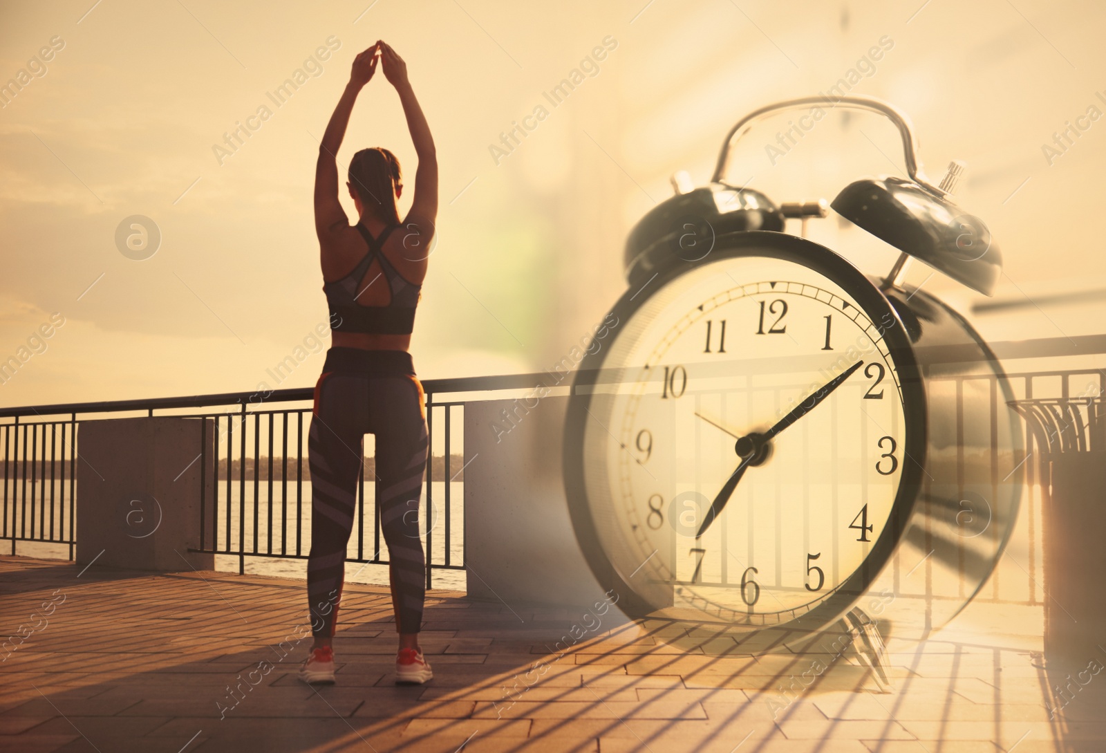 Image of Workout time. Double exposure of woman doing exercise on sunny morning outdoors and alarm clock