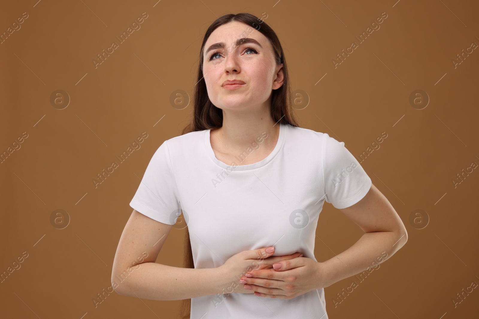 Photo of Woman having heart attack on brown background