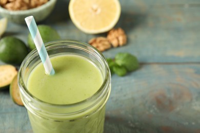 Fresh feijoa smoothie in glass on table, closeup. Space for text