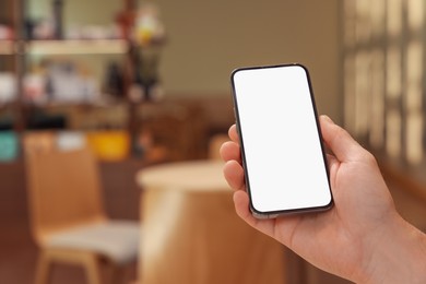 Photo of Man using smartphone in cafe, closeup. Space for text
