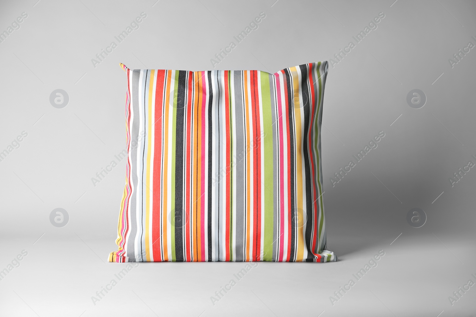 Photo of Soft decorative pillow on light background