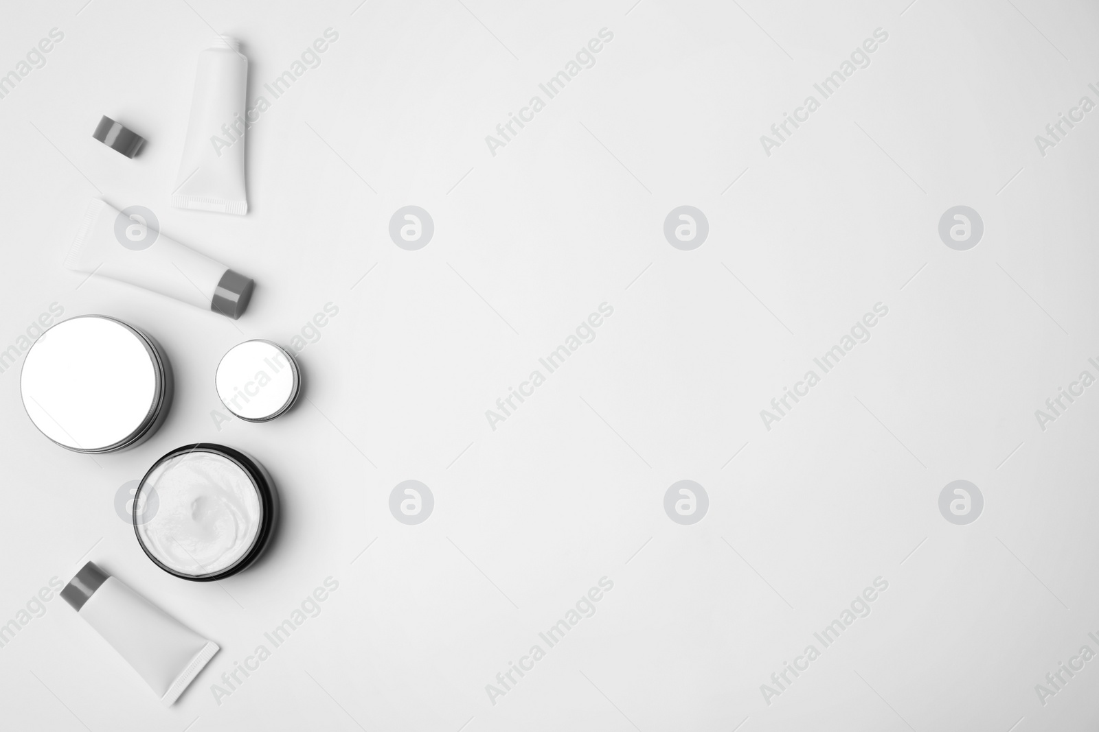 Photo of Flat lay composition with cosmetic products on light background