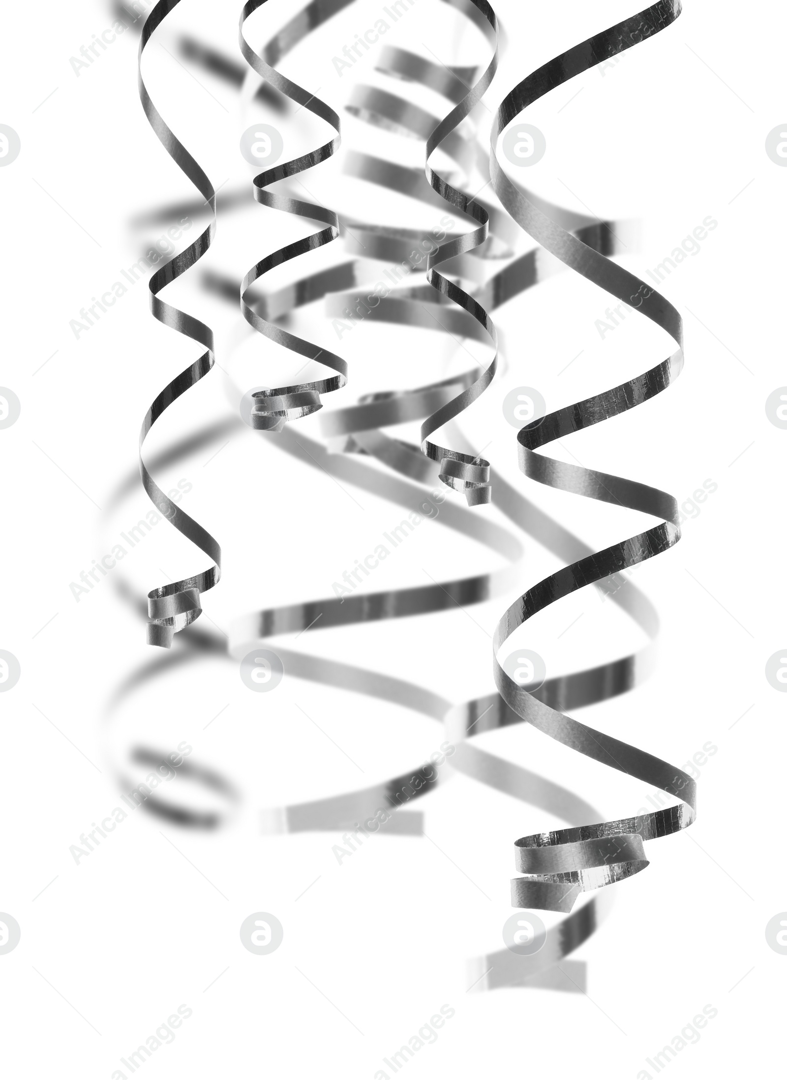 Image of Many silver serpentine streamers on white background. Party decor