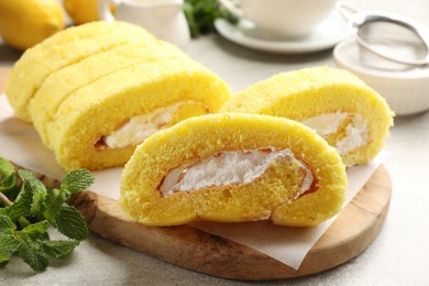 Photo of Delicious cake roll with cream filling on table, closeup