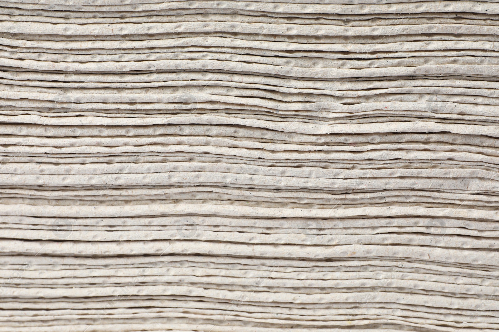 Photo of Texture staked of paper towels as background, closeup view