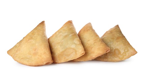 Fresh delicious crispy samosas on white background