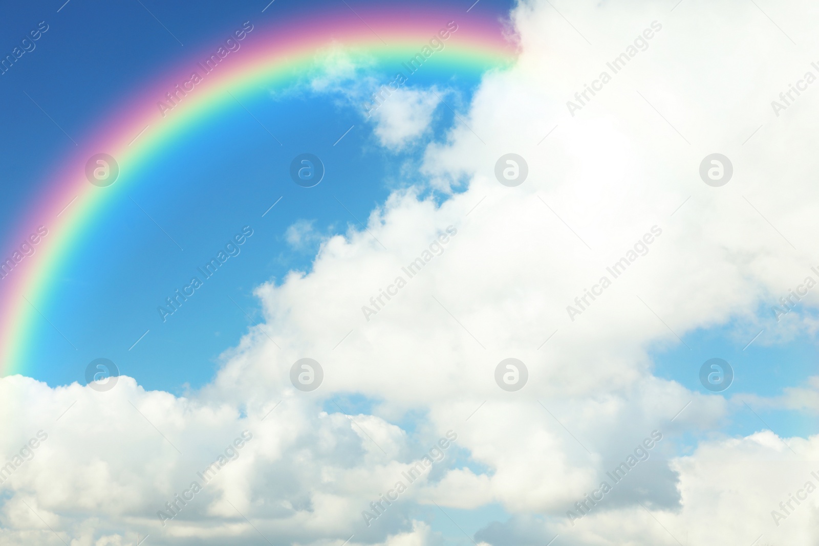 Image of Picturesque view of beautiful rainbow and blue sky on sunny day 