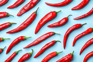 Photo of Flat lay composition with fresh chili peppers on color background