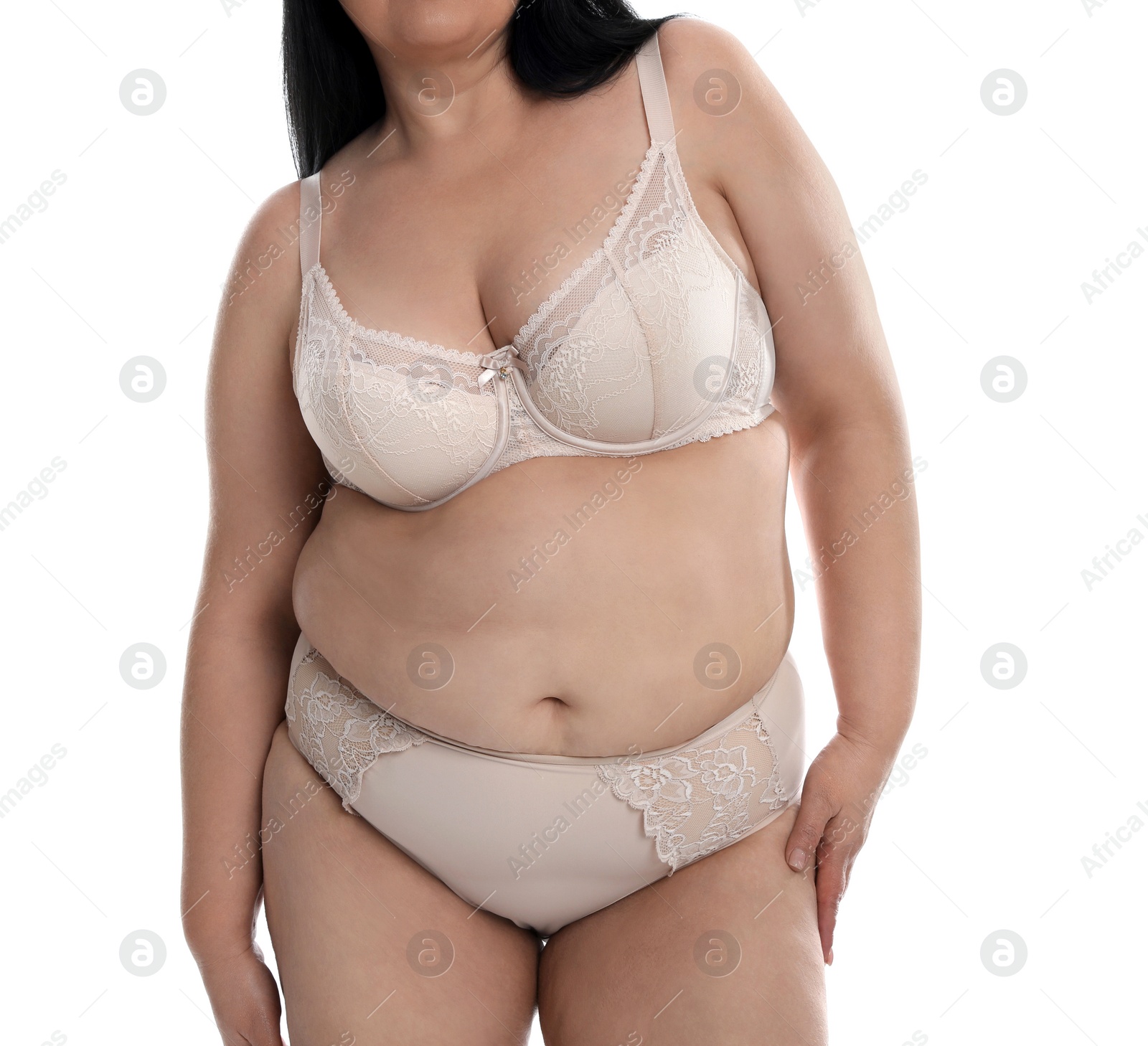Photo of Overweight woman in beige underwear on white background, closeup. Plus-size model