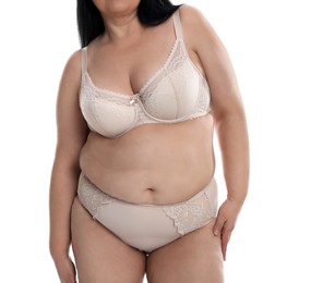 Photo of Overweight woman in beige underwear on white background, closeup. Plus-size model