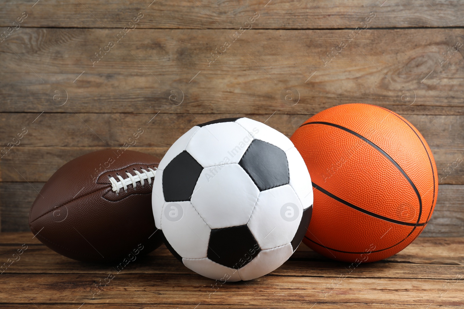 Photo of Set of different sport balls on wooden table