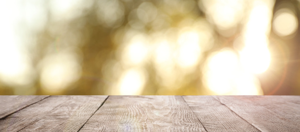 Empty wooden surface against blurred background. Bokeh effect