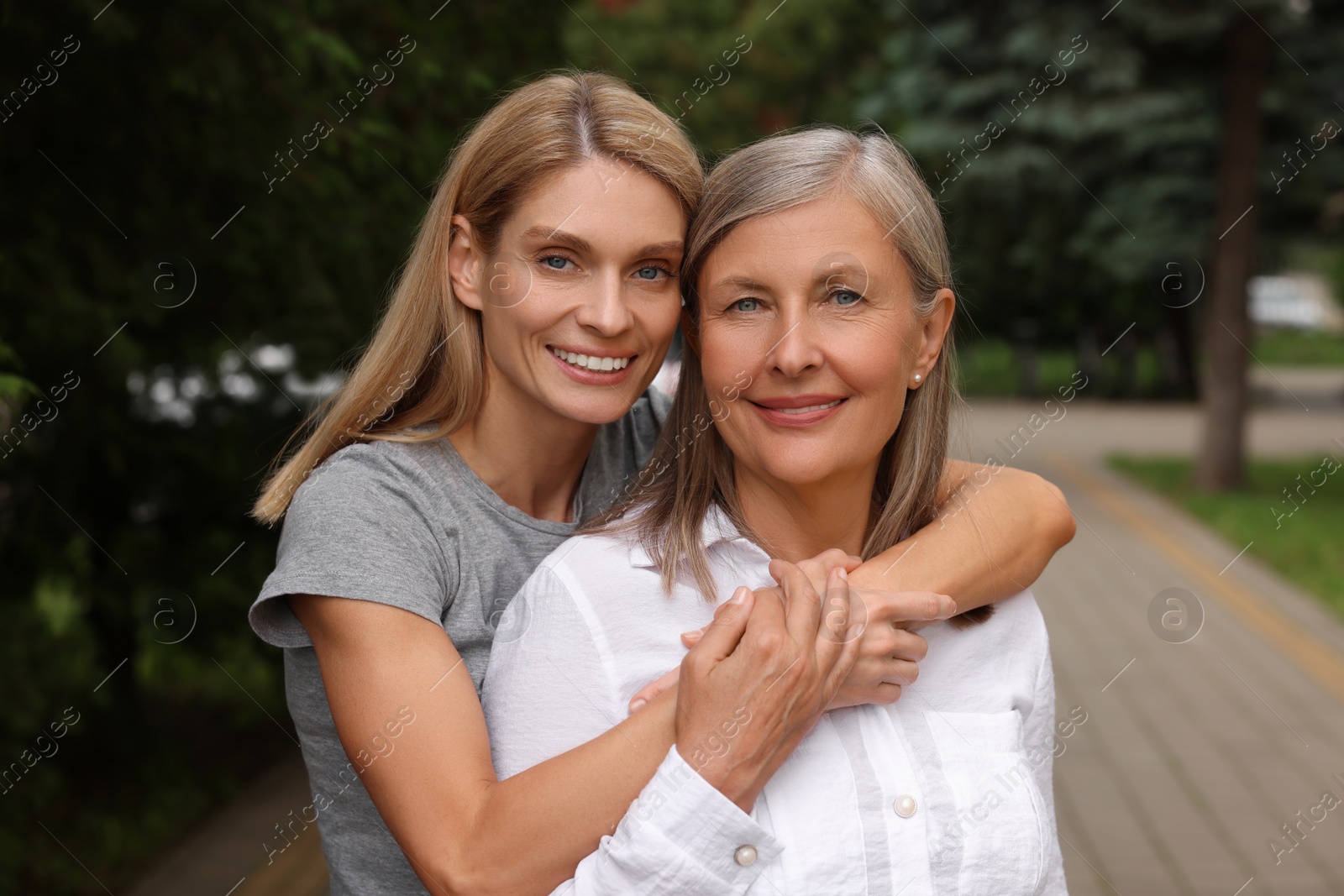 Photo of Happy mature mother and her daughter outdoors