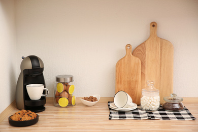 Photo of Modern coffeemaker on countertop near light wall in kitchen